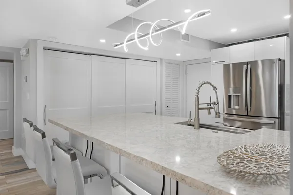 a work room with furniture and view of kitchen