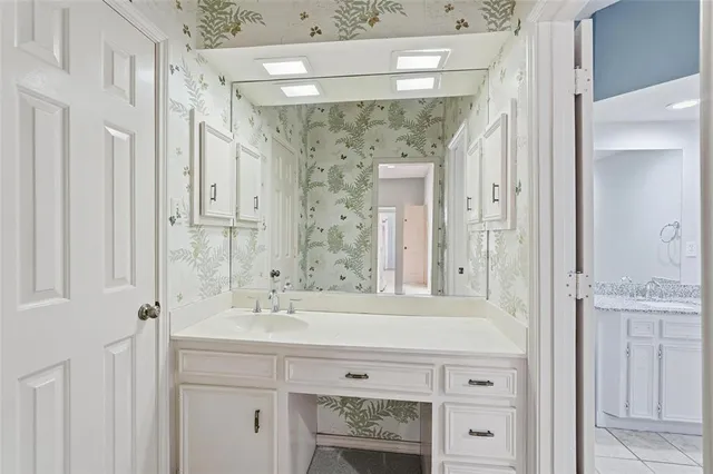a bathroom with a sink a mirror and a shower