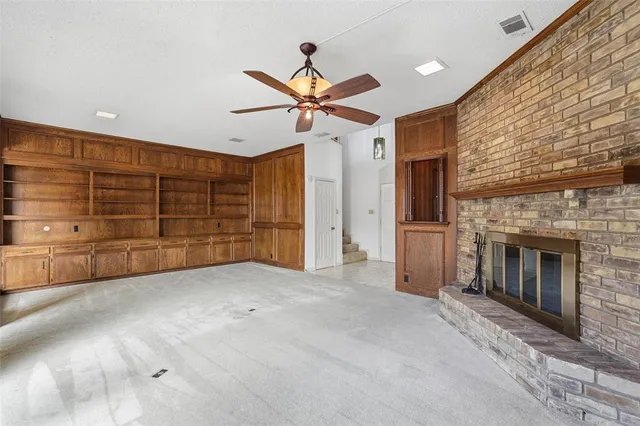 a view of a livingroom with a ceiling fan and window