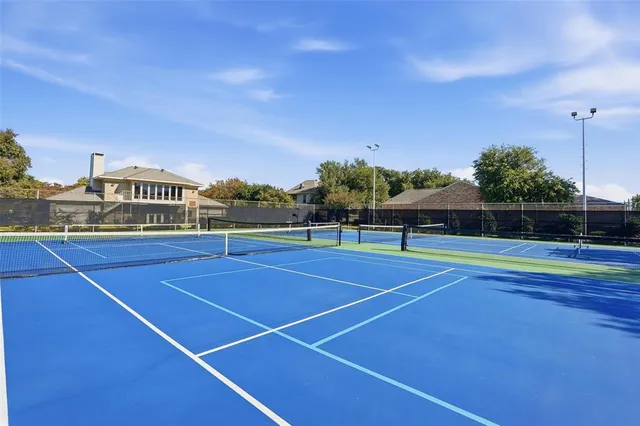 a view of tennis court with houses