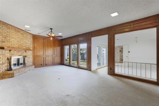 a view of an empty room with a fireplace