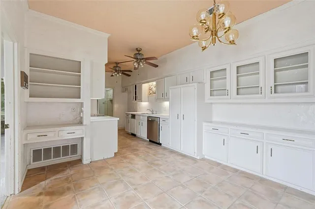 a view of a kitchen with a sink and cabinets