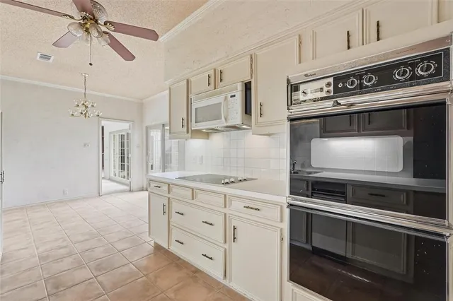 a kitchen with stainless steel appliances white cabinets and granite counter tops