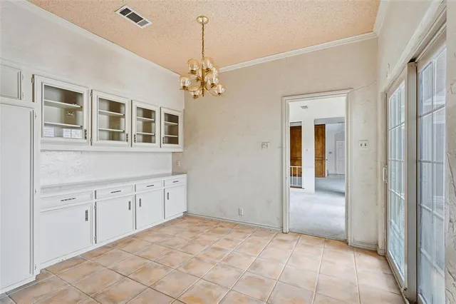 a large white kitchen with granite countertop cabinets a sink and dishwasher