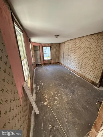 a view of a livingroom with wooden floor and staircase