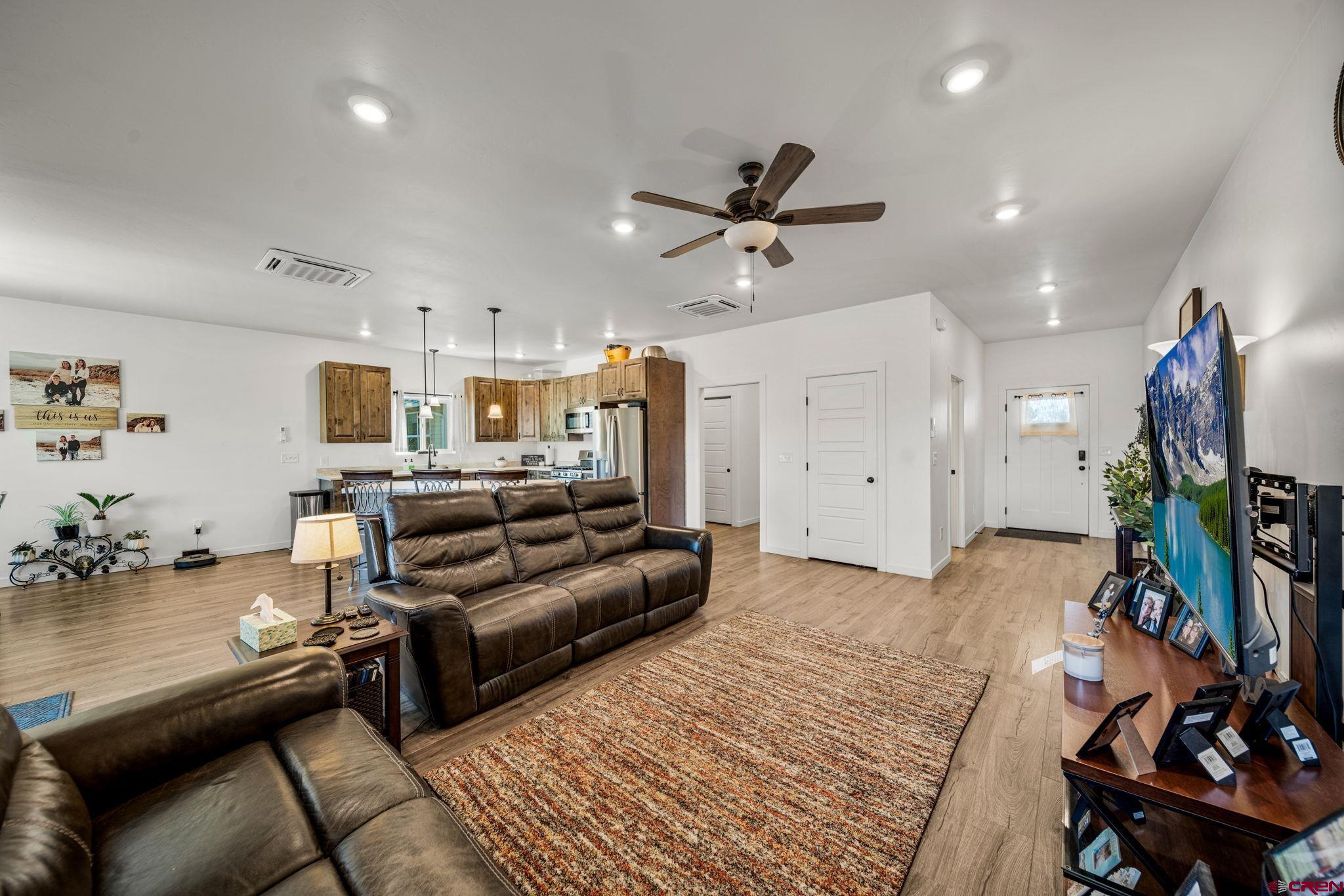 215 West Menefee Street Mancos, CO 81328 - Photo 13 of 29 a living room with furniture and a wooden floor