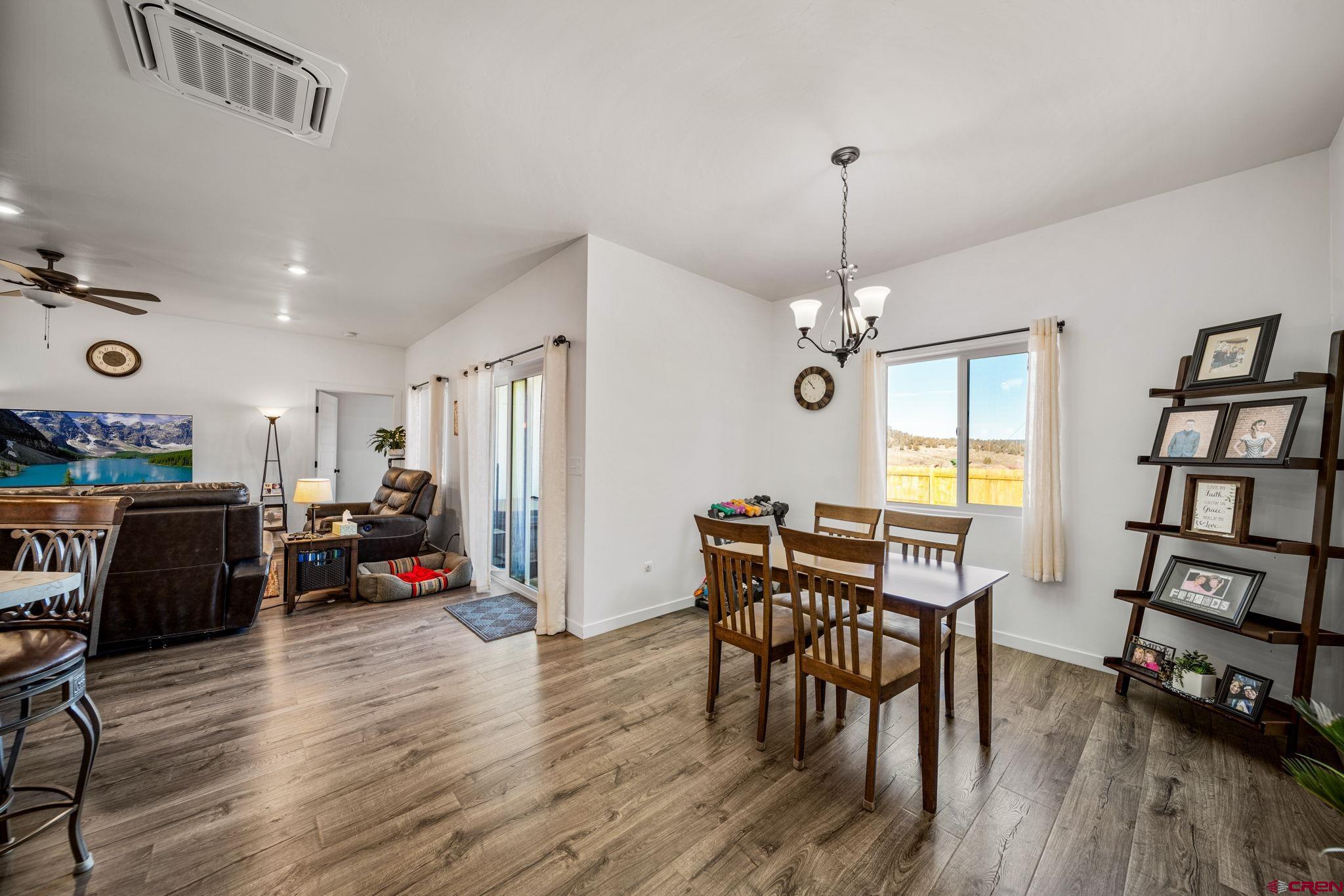 215 West Menefee Street Mancos, CO 81328 - Photo 19 of 29 a view of a dining room with furniture and wooden floor