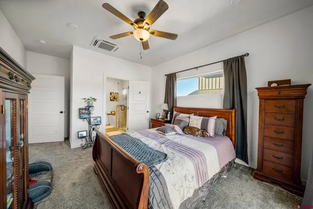 a bed room with a bed and a chandelier