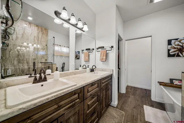 a bathroom with a sink double vanity and a mirror