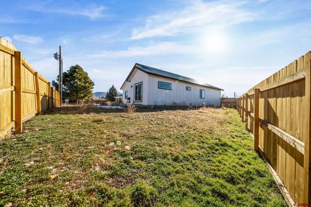 a view of a house with wooden fence
