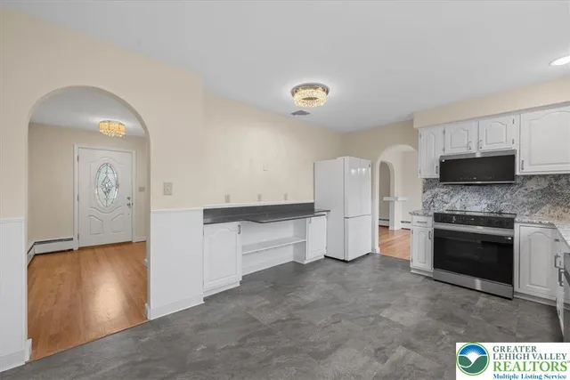 a kitchen with a refrigerator and a stove
