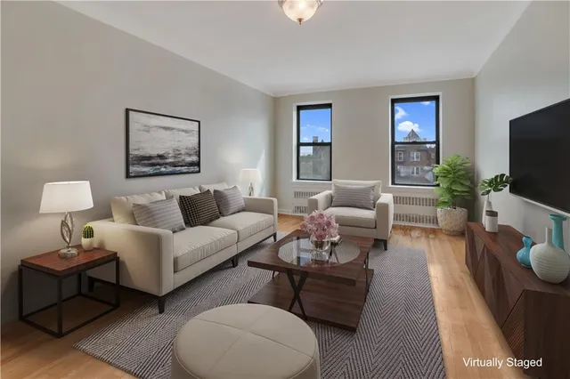 a living room with furniture a flat screen tv and a couch