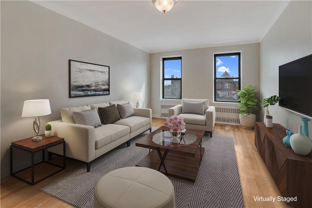 a living room with furniture a flat screen tv and a couch
