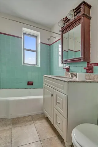 a bedroom with bed and painting on the wall