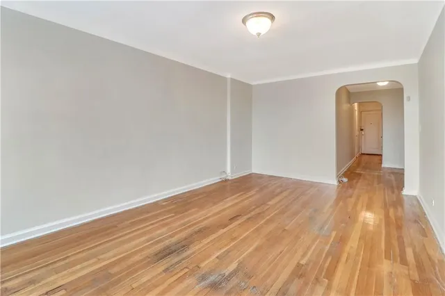 a view of a room with wooden floor and white walls