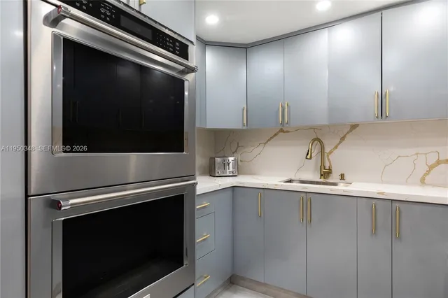 a kitchen with a sink and stainless steel appliances