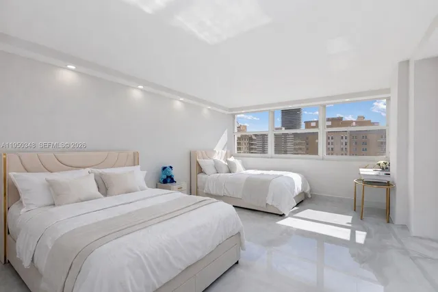 a bedroom with two beds and a window