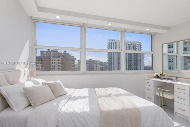 a bedroom with a large window and a bed