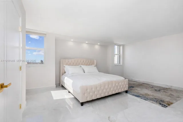 a bedroom with a bed and a night stand