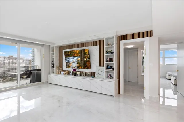 a large white room with a large window and furniture