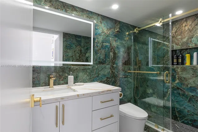 a bathroom with a sink toilet and shower