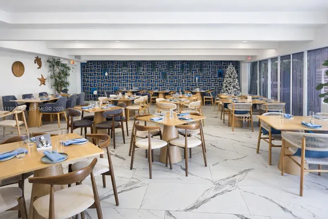 a dining room with furniture a large window and a table