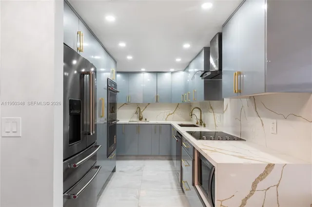 a kitchen with a sink and stainless steel appliances
