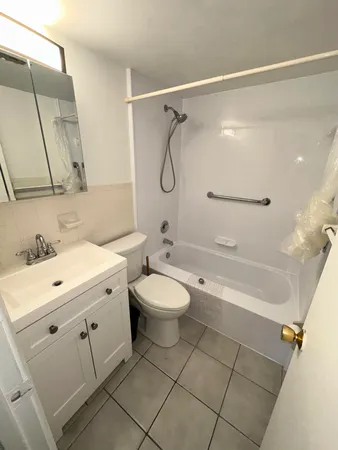 a bathroom with a granite countertop toilet a sink and a mirror