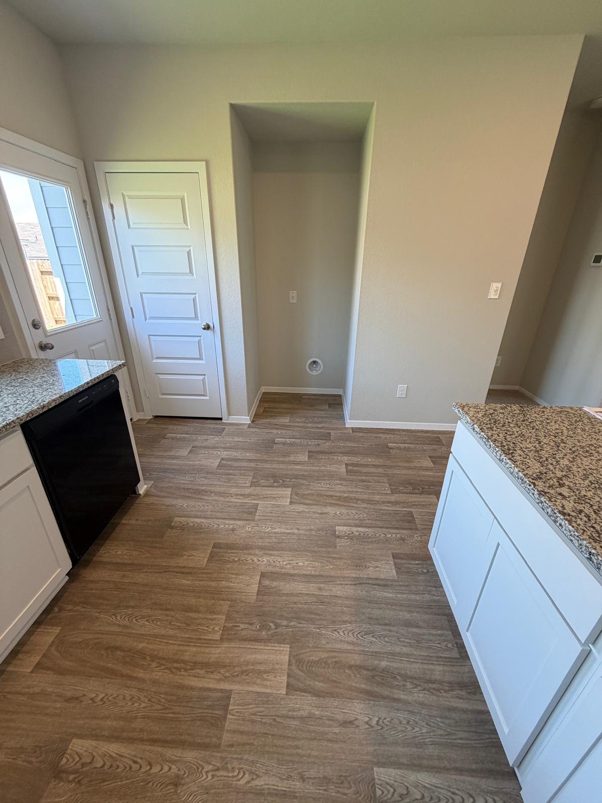 2612 Towy Road Manor, TX 78653 - Photo 24 of 35 A well-appointed kitchen features rich wood flooring and practical counter space, perfect for culinary endeavors.