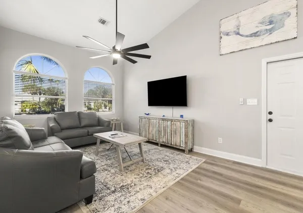a living room with furniture and a flat screen tv
