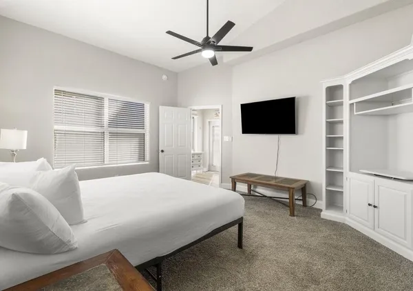 a bedroom with a bed and a flat screen tv