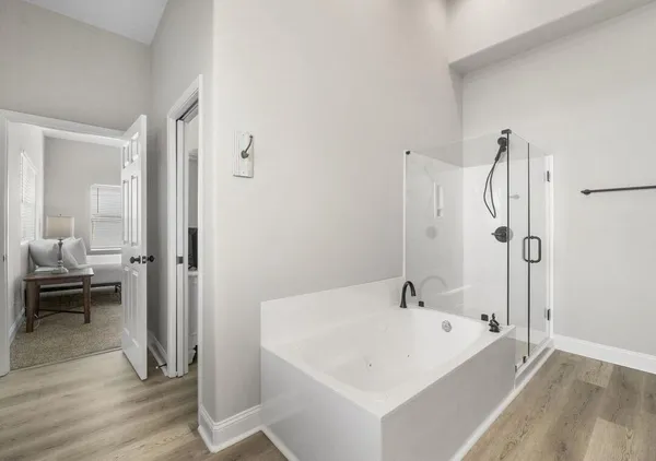 a white bath tub sitting next to a bathroom