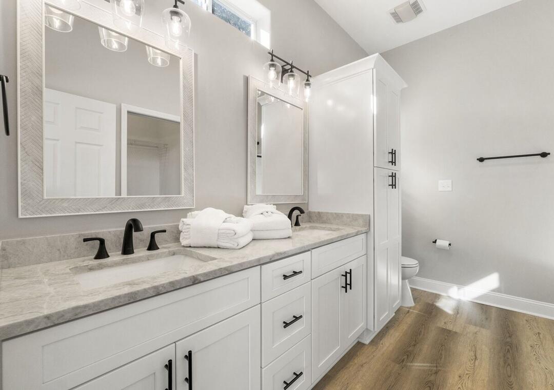 108 Terra Cotta Way Destin, FL 32541 - Photo 19 of 42 a bathroom with a double vanity sink and mirror with toilet