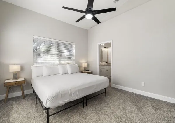 a bedroom with a bed dresser and a window