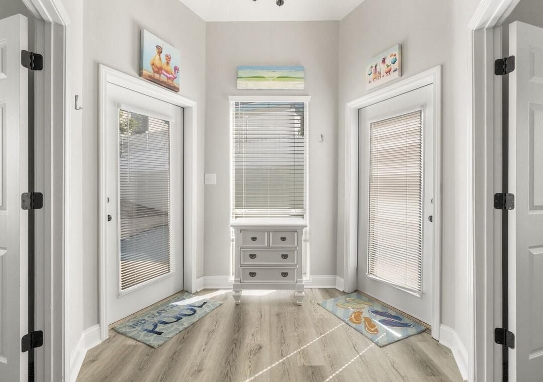 108 Terra Cotta Way Destin, FL 32541 - Photo 22 of 42 a view of a bedroom with wooden floor and windows