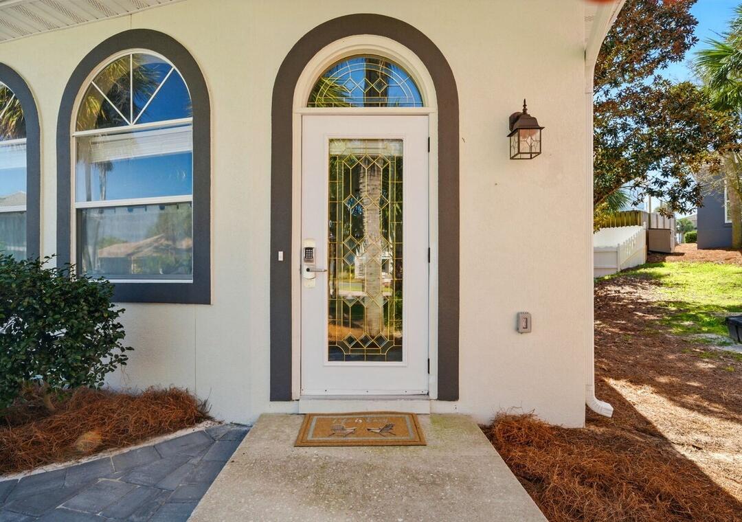 108 Terra Cotta Way Destin, FL 32541 - Photo 24 of 42 a front view of a house with garden