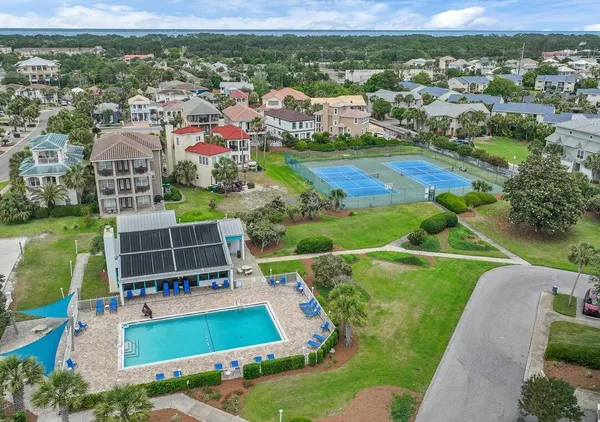 an aerial view of residential houses with outdoor space and pool