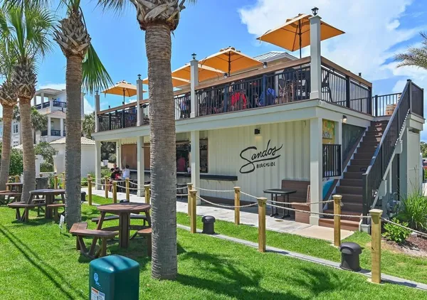 a front view of a house with a yard table and chairs