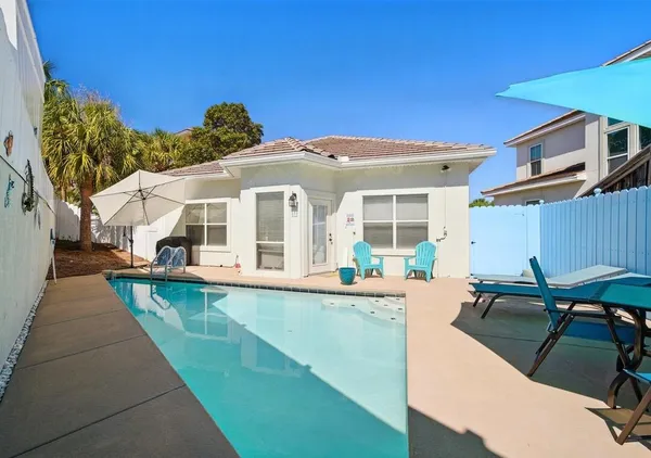 a view of a house with pool table and chairs