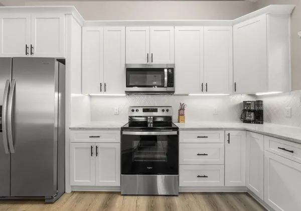 a kitchen with cabinets and stainless steel appliances