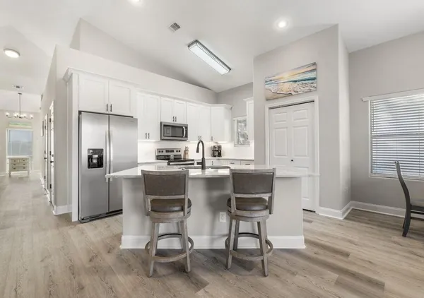 a dining room with furniture and a kitchen view