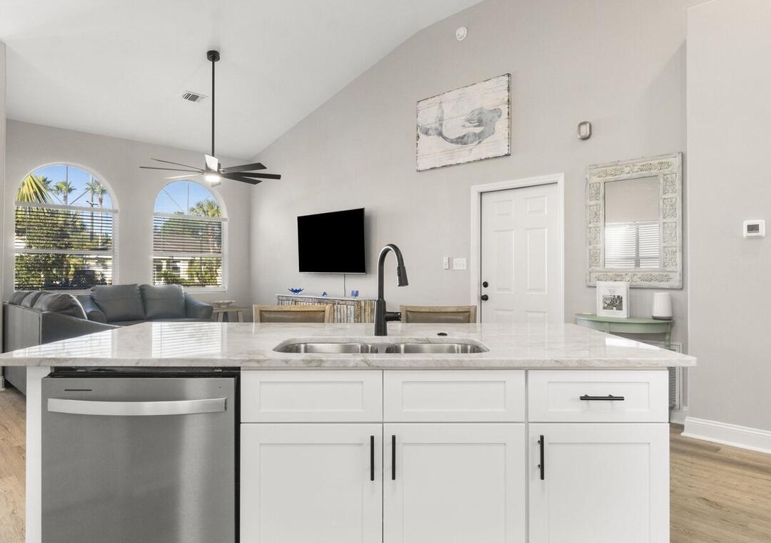 108 Terra Cotta Way Destin, FL 32541 - Photo 10 of 42 a room with kitchen island a sink and a flat screen tv