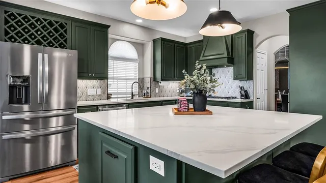 a kitchen with stainless steel appliances a sink and a refrigerator