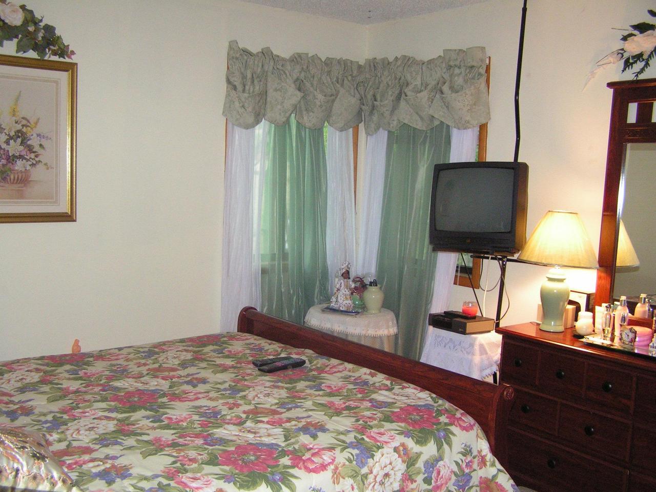 1038-15 Decker Road Arcadia, LA 71001 - Photo 14 of 19 a bedroom with a bed and a flat tv screen on dresser
