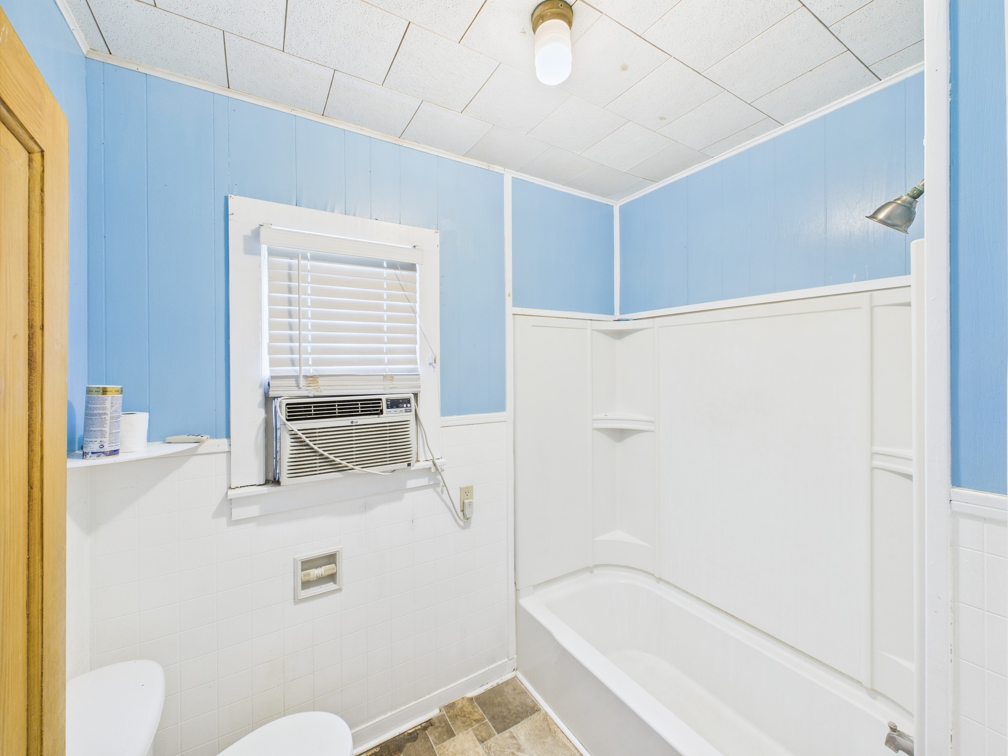305 West Converse Street Weimar, TX 78962 - Photo 16 of 30 a bathroom with a bathtub and a shower