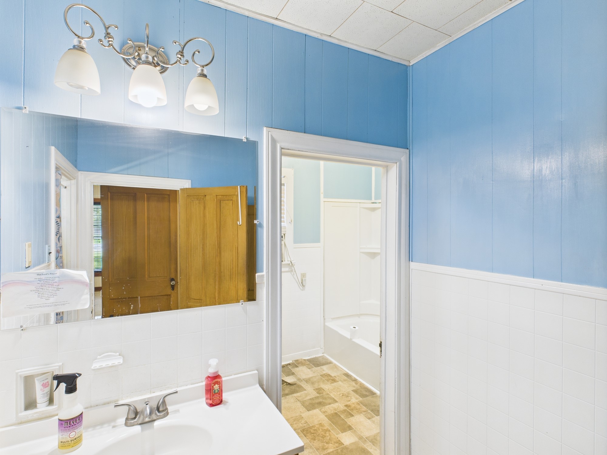 305 West Converse Street Weimar, TX 78962 - Photo 17 of 30 a bathroom with a sink and a mirror