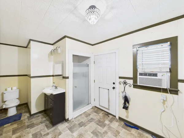 a view of a livingroom with wooden floor and a ceiling fan