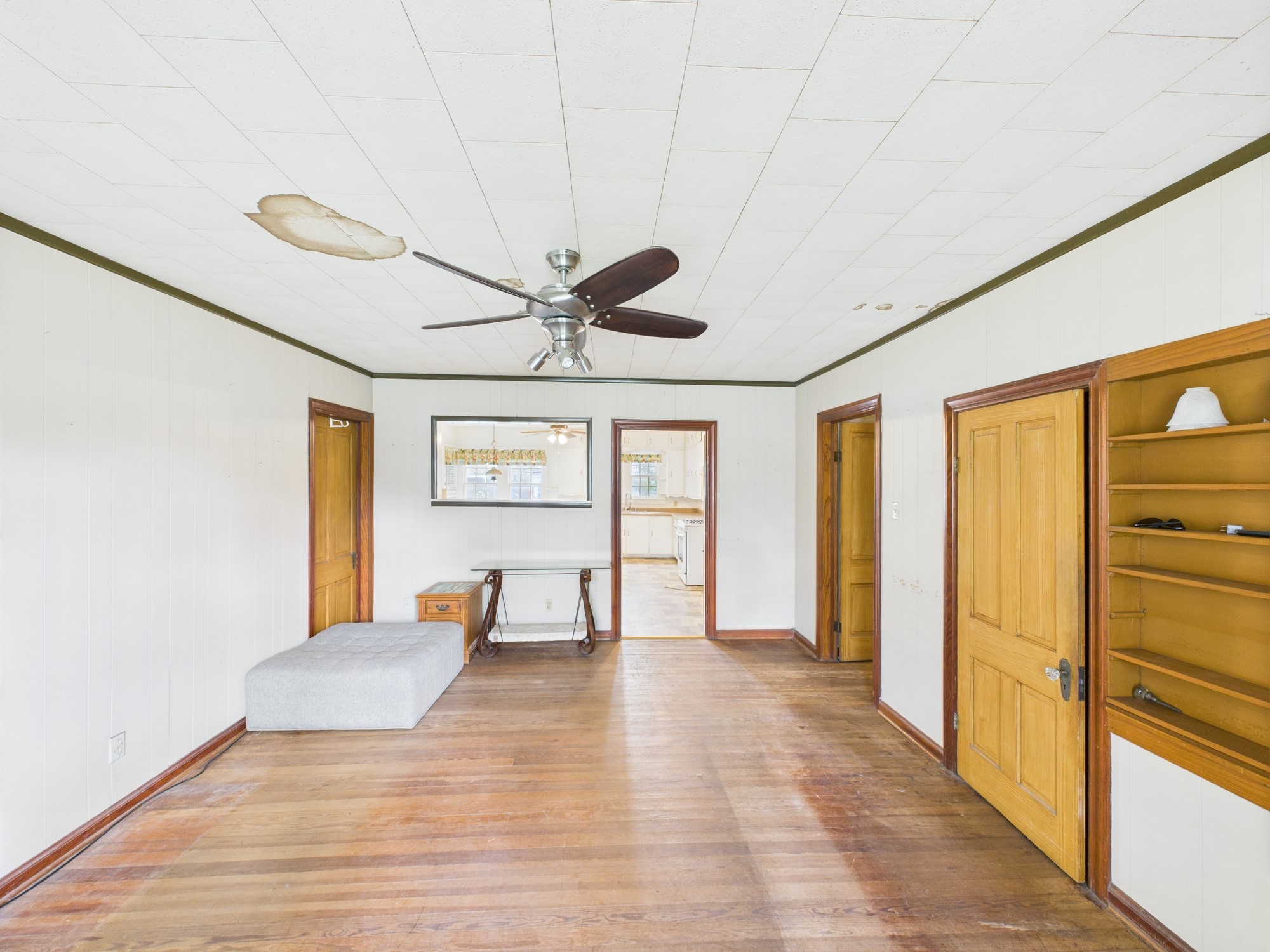 305 West Converse Street Weimar, TX 78962 - Photo 20 of 30 a view of a livingroom with wooden floor and a ceiling fan