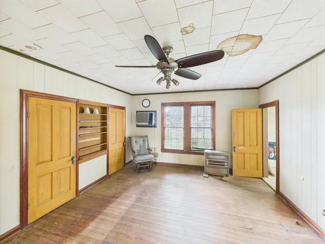 a bedroom with furniture and a large window