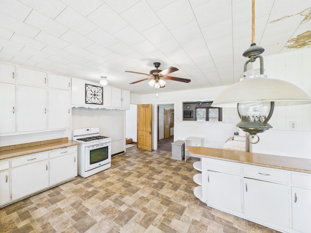 305 West Converse Street Weimar, TX 78962 - Photo 25 of 30 a kitchen with stainless steel appliances granite countertop a sink and cabinets